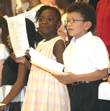 Ashlene Exavier and Juan Daniel Gomez, both third graders at St. Andrew School, sing "Make A Joyful Noise" during the interfaith Thanksgiving service held Nov. 24. They are part of the joint children's choir from Temple Beth Orr, Congregation Kol Tikvah, First United Methodist Church and St. Andrew Parish.