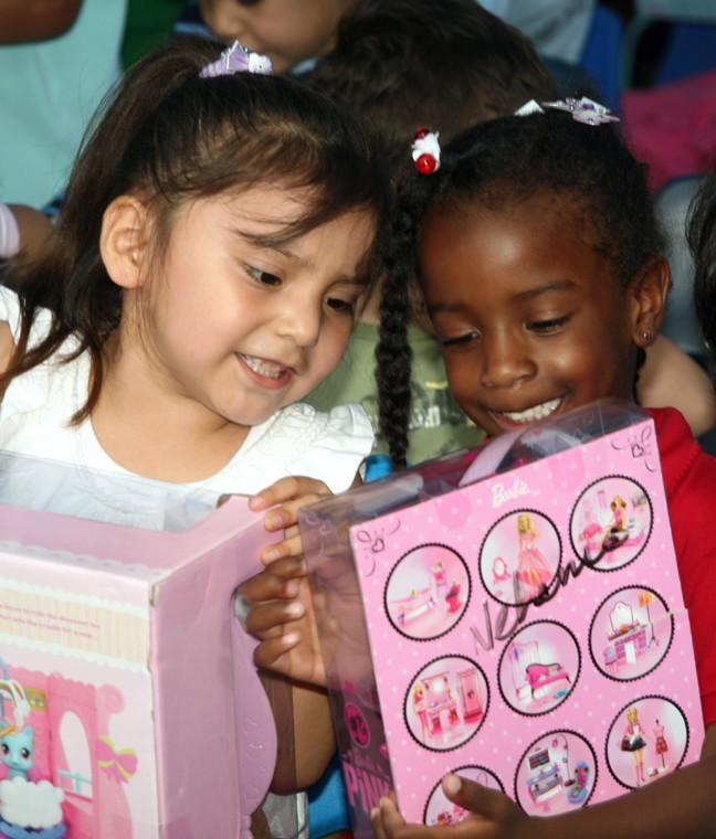 Children compare toys after Santa Claus's visit.