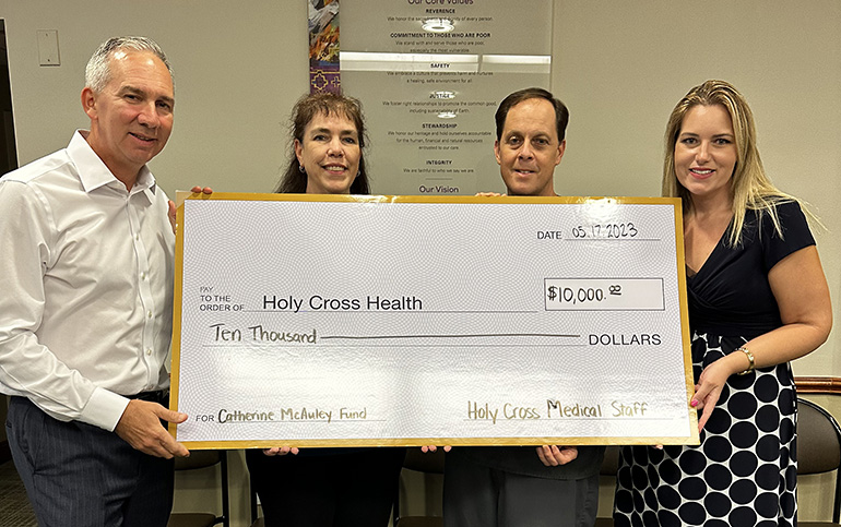 ADOM :: Holy Cross medical staff donates $10,000 to help colleagues